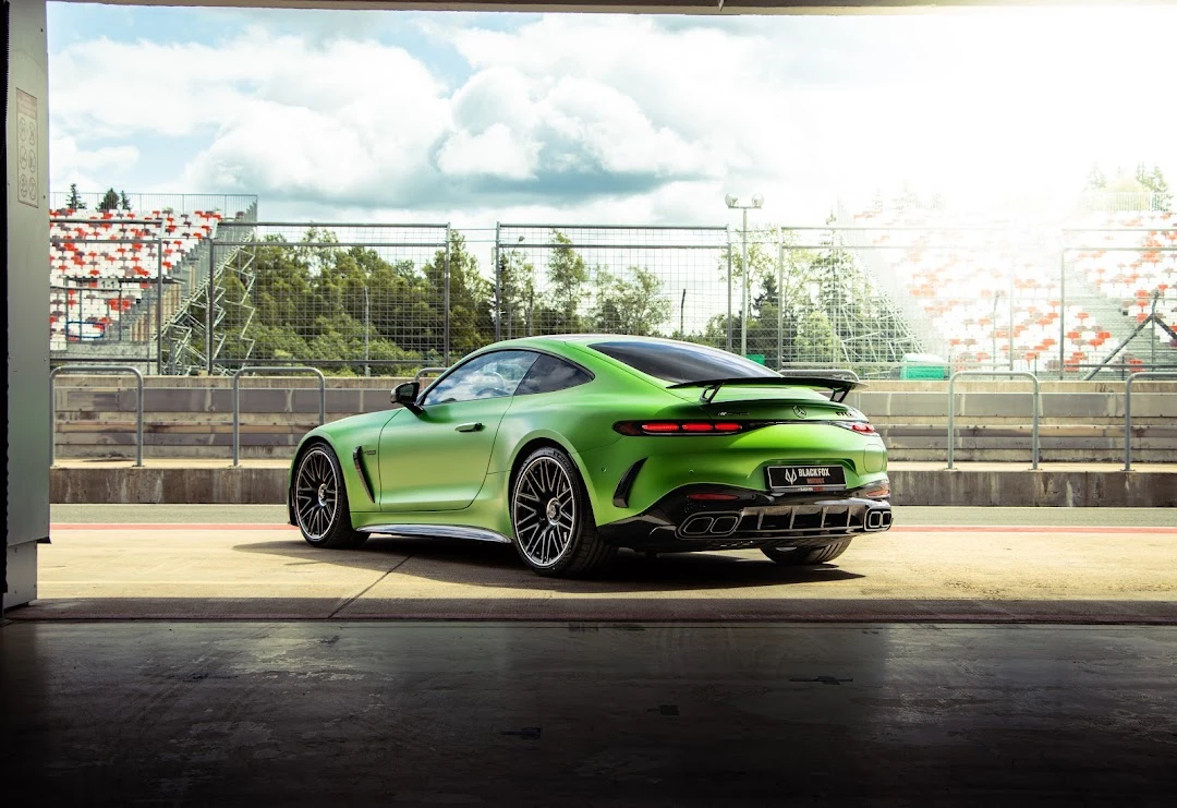 Green Mercedes framed by light and architecture